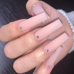 Long square matte nude pink press-on nails decorated with iridescent rhinestones
