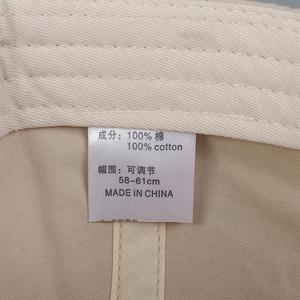 Macro shot of 100% cotton baseball cap interior detail with size adjustment label
