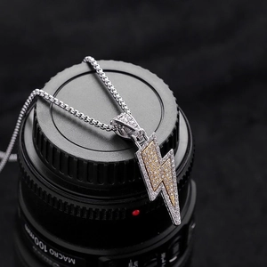 Hip hop silver chain necklace featuring a gold and silver lightning bolt pendant with crystals