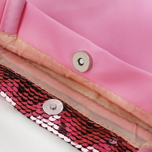 Close-up of pink sequin girl handbag showing magnetic snap closure and faux leather lining