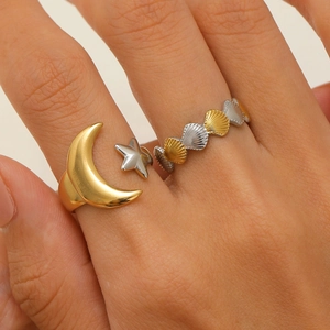 Detail of 18K gold-plated adjustable moon ring and shell band on model's hand