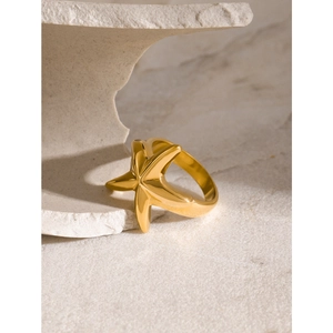 Minimalist 18k gold plated stainless steel starfish ring on a white stone base