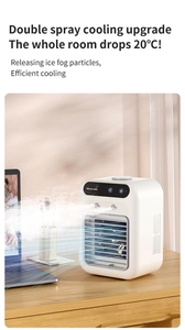 Mini USB air cooler with dual spray nozzles on an office desk with laptop