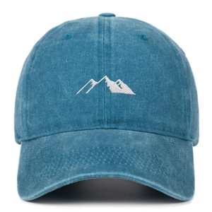 Detailed close-up of mountain peak embroidery on a washed vintage baseball cap