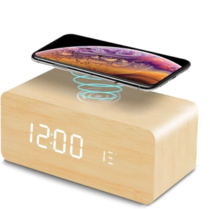Detail of wooden LED alarm clock with wireless charging pad and temperature display
