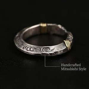 Handcrafted silver-tone arrowhead ring with vintage wave carvings and gold wire details