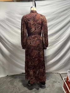 Detail of bohemian red-brown paisley chiffon maxi dress with ruffled hem and waist cut