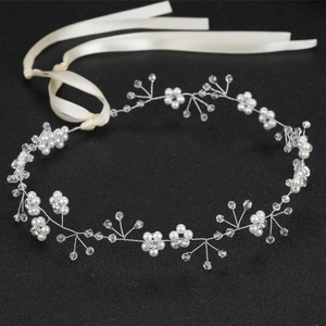Handmade bridal headband with white pearls and crystals on black background