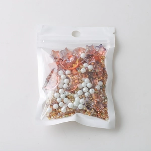 Close-up of mixed star and moon beads in pink glitter and white for DIY jewelry