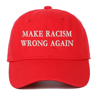 Detailed close-up of white 'Make Racism Wrong Again' embroidery on red cotton baseball cap