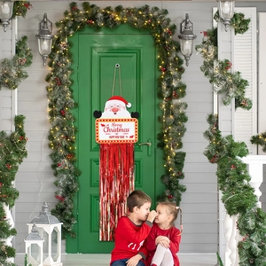 Detail of Christmas Santa hanging sign with Merry Christmas text and red metallic tassels