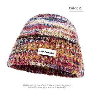 Detail of multi-color gradient knit bucket hat with Love Fashion square label