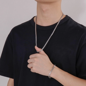 Polished stainless steel Cuban link necklace and bracelet set worn by a male model