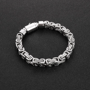 Close-up of a silver Byzantine chain bracelet with a square clasp on black texture