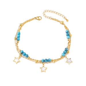 Double-layered gold anklet with turquoise beads and star pendants on a white background