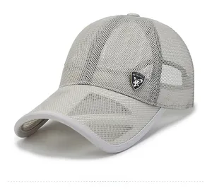 Macro detail of breathable grey mesh fabric and metal shield logo on summer baseball cap