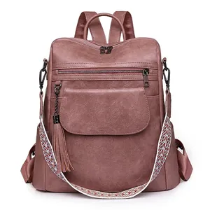 Dusty pink vintage faux leather backpack with ethnic pattern strap and tassel detail