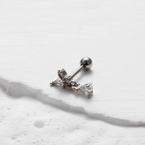 Macro detail of silver stainless steel stud earring with sparkling cubic zirconia on stone