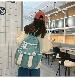 Detail of teal and beige canvas backpack with cute rabbit ears and ifan Rabbit logo