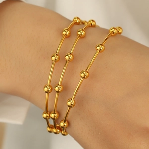 Minimalist gold beaded stainless steel bangle bracelet with a high polished finish for women