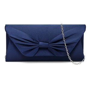 Macro shot of dark blue satin texture with butterfly knot and silver metal chain