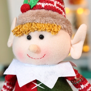 Close-up of colorful Christmas elf plush dolls in warm festive indoor setting decor