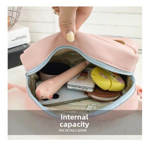 Interior view showing small pink cross body bag capacity for phone and makeup