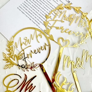 Golden acrylic Mr&Mrs wedding cake toppers set with elegant floral and heart designs