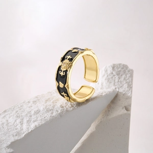 18K gold plated crown ring with black enamel and zircons on a natural stone base