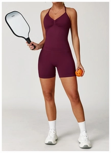 Detail of burgundy seamless sports vest with ruched chest design and elastic fabric