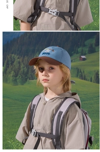 Detailed embroidery and contrast color design of a kids outdoor baseball cap in a scenic setting