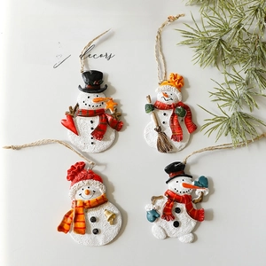 Set of four resin snowman ornaments with festive scarves and hats for Christmas trees