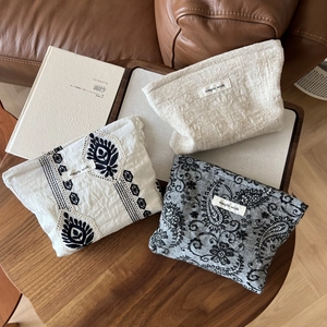 Three-piece set of linen cosmetic bags with black embroidery and simple wish brand labels
