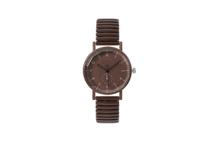 Close-up of vintage brown quartz watch with stretch band and round numeric dial