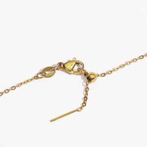 Macro shot of gold stainless steel necklace lobster clasp and adjustable slider bead
