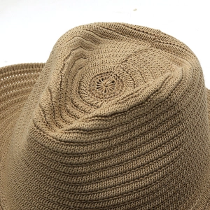 Detailed macro view showing the spiral woven texture and khaki cotton yarn of the sun hat