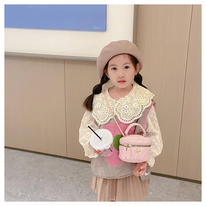 Close-up of pink quilted round crossbody bag for girls with golden hardware detail