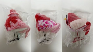 Detailed view of three handcrafted Valentine bird figurines with heart patterned scarves