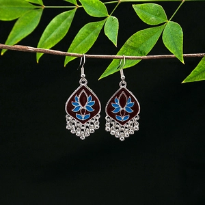 Detail of bohemian lotus earrings with blue red enamel and silver tassel beads