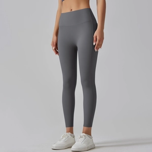 Macro detail of high-waisted yoga pants side stitching and matte elastic fabric texture
