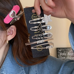 Detailed close-up of Y2K heart and star hair clips set with sparkling rhinestones