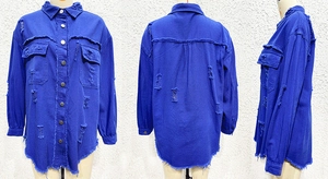 Detail view of frayed hem and distressed denim jacket with fringe and metal buttons