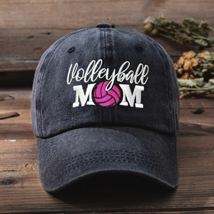 Close-up of Volleyball MOM embroidery on dark grey washed cotton baseball cap with texture detail