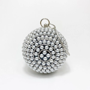 Macro shot of sphere evening bag featuring faux pearl inlay and sparkling rhinestones