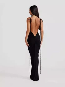 Elegant black backless bodycon maxi dress with ruched detail and tasseled shoulder straps