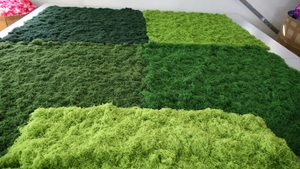 Comparison of different green shades and textures of artificial moss for landscape decor