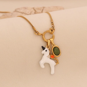 Golden snake chain necklace featuring a white unicorn pendant and a green gemstone charm
