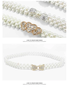 Detailed macro view of elegant pearl belt buckles with sparkling rhinestone heart and bow