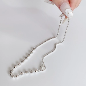 Detail of 925 sterling silver ball chain necklace with minimalist OT toggle clasp design