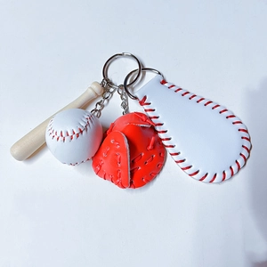 Close-up of baseball keychain set with mini wooden bat, glove and white baseball charms